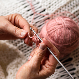 high view person knitting with pink thread 1