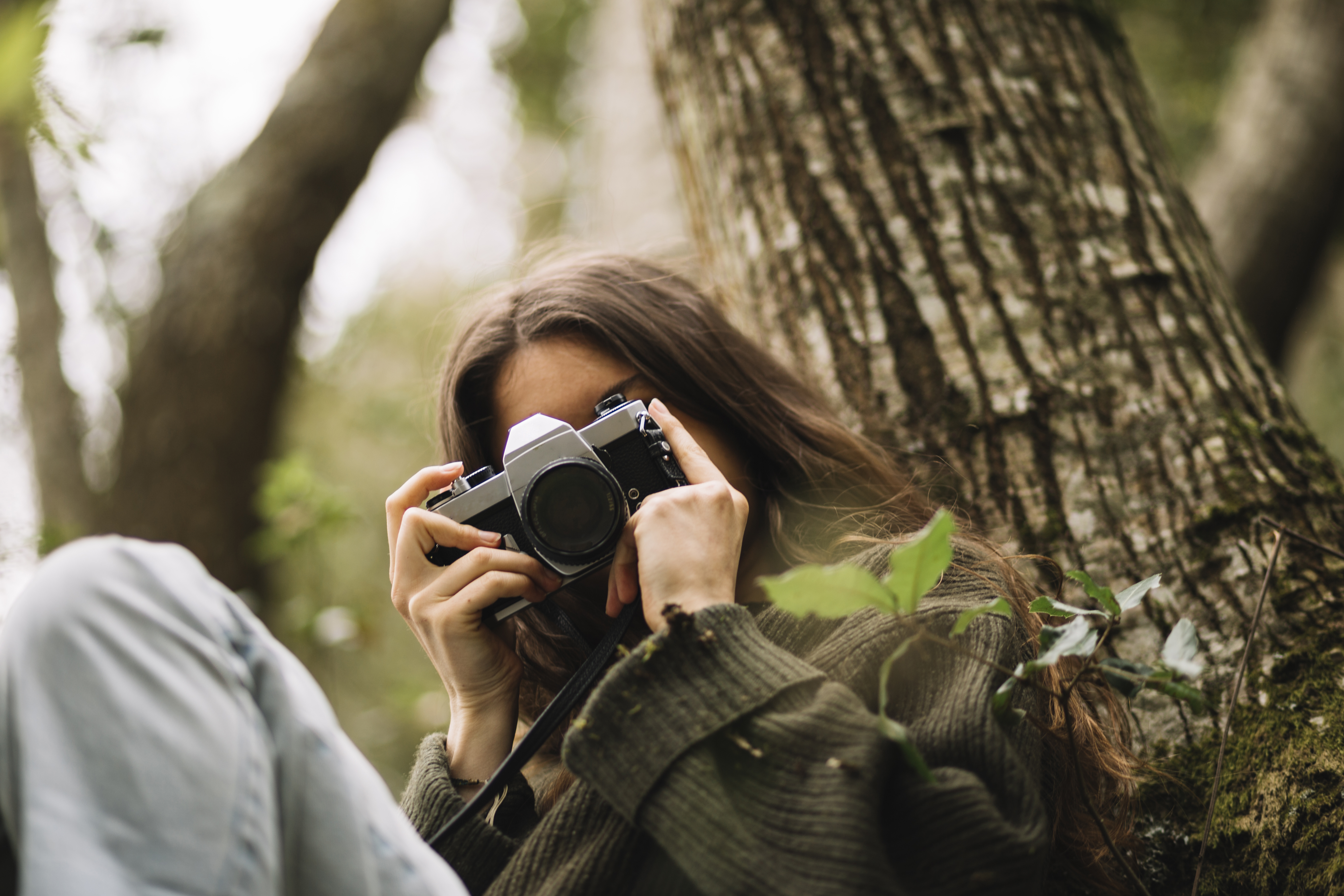 young woman taking photo nature